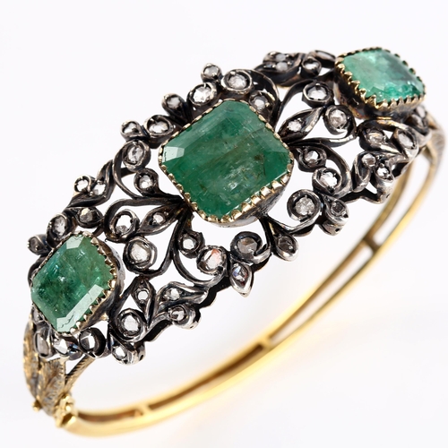 120 - A fine Victorian emerald and diamond hinged bangle, unmarked gold and silver-topped openwork setting... 