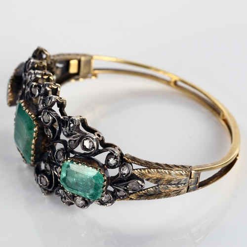 120 - A fine Victorian emerald and diamond hinged bangle, unmarked gold and silver-topped openwork setting... 