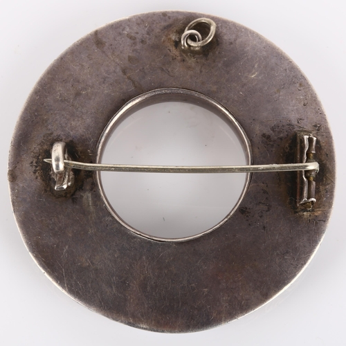 124 - A 19th century Scottish hardstone brooch, unmarked silver closed-back settings in circular form, wit... 