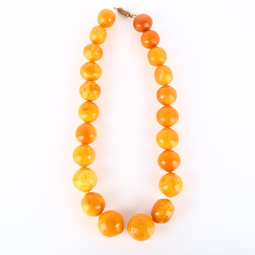 125 - A graduated single-strand butterscotch amber bead necklace, beads ranging from 26.9mm to 23mm, neckl... 