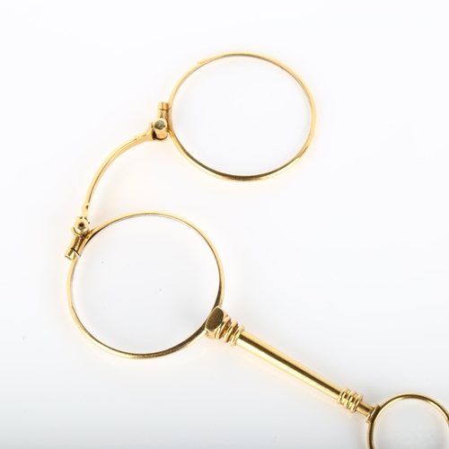 127 - A pair of 19th century French gold lorgnettes, with ring turned spring release catch, closed length ... 