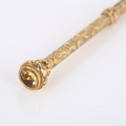 129 - A 19th century propelling pencil, unmarked yellow metal settings with engraved foliate decoration an... 