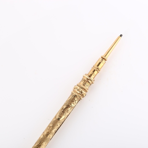 129 - A 19th century propelling pencil, unmarked yellow metal settings with engraved foliate decoration an... 