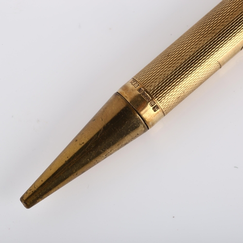 130 - A mid-20th century 9ct gold combination propelling pencil/ballpoint pen, engine turned case with 9ct... 