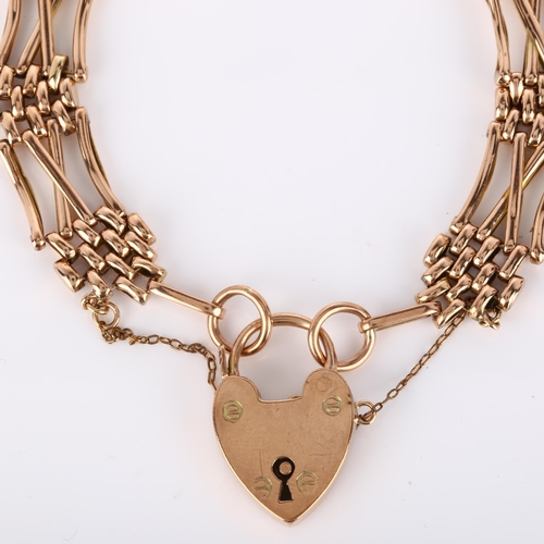 134 - An early/mid-20th century unmarked rose gold gatelink bracelet, with 9ct heart padlock clasp, maker'... 