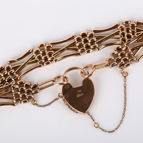 134 - An early/mid-20th century unmarked rose gold gatelink bracelet, with 9ct heart padlock clasp, maker'... 