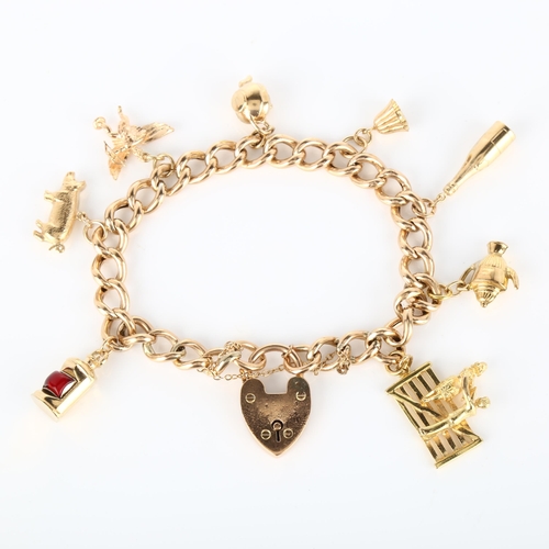 136 - A mid-20th century 9ct gold hollow curb link charm bracelet, with 8 gold charms and heart padlock cl... 