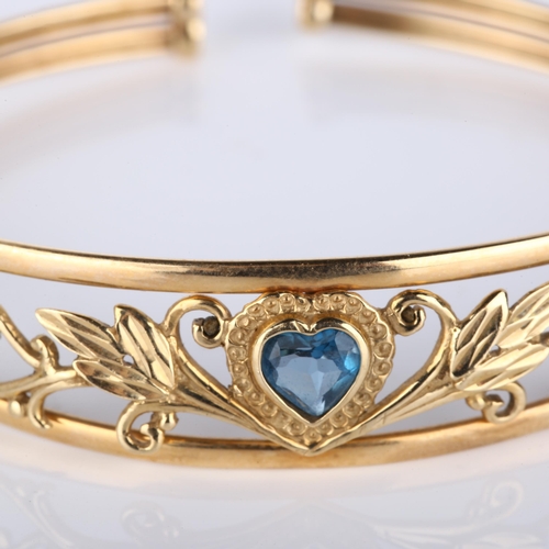 139 - A modern 9ct gold blue topaz heart torque bracelet, openwork floral design, setting height 13.9mm, i... 