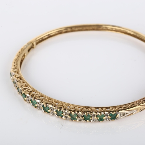 140 - A 9ct gold emerald and diamond hinged bangle, set with round-cut emerald and single-cut diamonds, ba... 