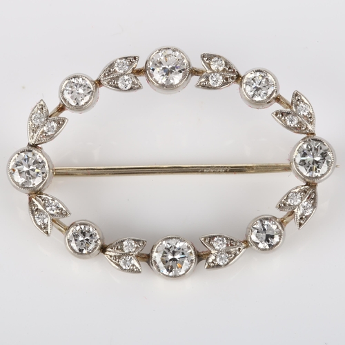 144 - A Belle Epoque diamond brooch, openwork oval form with floral design set with modern round brilliant... 