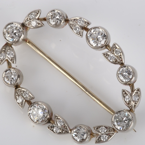 144 - A Belle Epoque diamond brooch, openwork oval form with floral design set with modern round brilliant... 