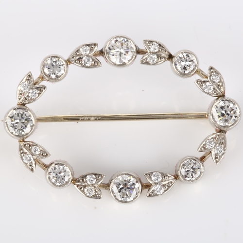 144 - A Belle Epoque diamond brooch, openwork oval form with floral design set with modern round brilliant... 