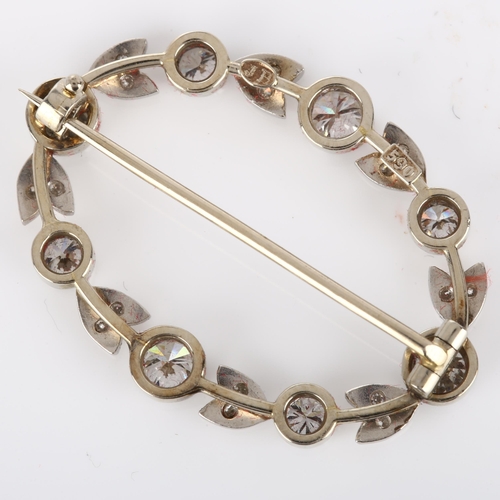 144 - A Belle Epoque diamond brooch, openwork oval form with floral design set with modern round brilliant... 