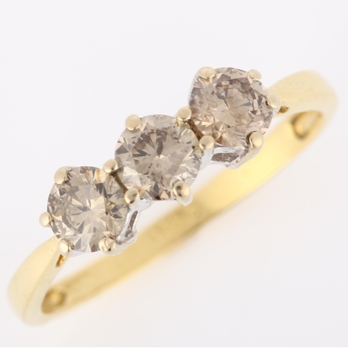 148 - An 18ct gold three stone brown diamond ring, claw set with modern round brilliant-cut diamonds, clar... 