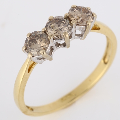 148 - An 18ct gold three stone brown diamond ring, claw set with modern round brilliant-cut diamonds, clar... 