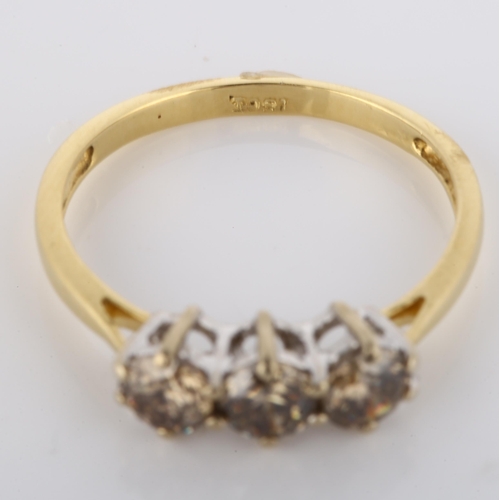 148 - An 18ct gold three stone brown diamond ring, claw set with modern round brilliant-cut diamonds, clar... 