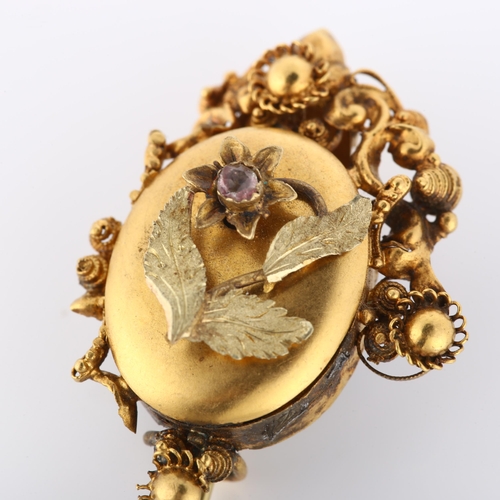 149 - A Victorian Etruscan style mourning brooch, with stone set flower motif, cannetille surround and mem... 