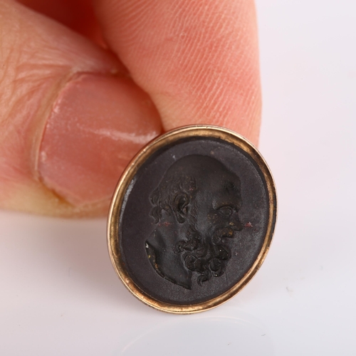 159 - An Antique hardstone ring stone, intaglio carved depicting Aristotle, in unmarked gold fob mount, se... 