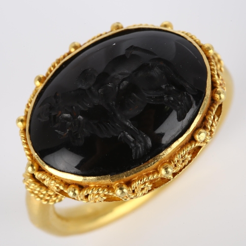 160 - A Victorian style seal ring, unmarked high carat gold settings with wirework surround and intaglio c... 