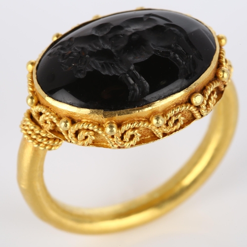 160 - A Victorian style seal ring, unmarked high carat gold settings with wirework surround and intaglio c... 