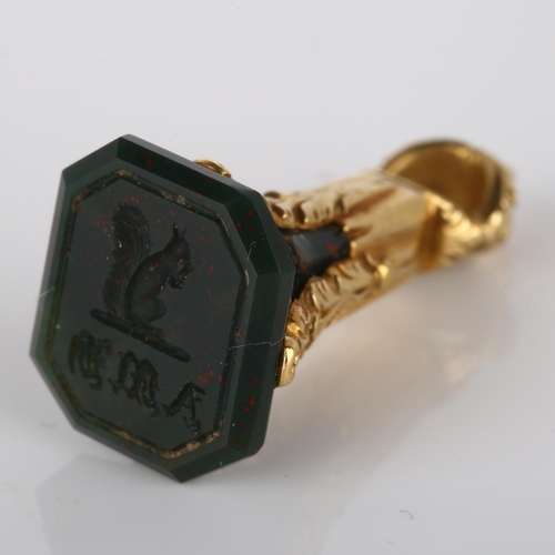 163 - A small Victorian bloodstone seal fob, intaglio carved with squirrel emblem and initials below, in u... 