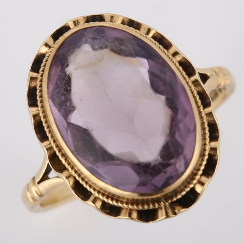 175 - A late 20th century 9ct gold amethyst dress ring, set with oval mixed-cut amethyst, hallmarks London... 