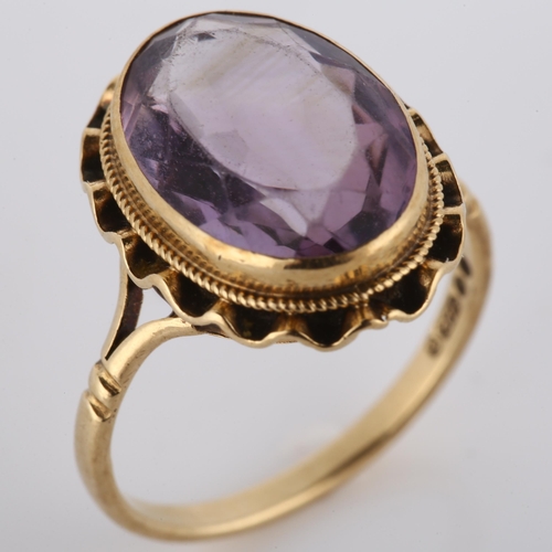 175 - A late 20th century 9ct gold amethyst dress ring, set with oval mixed-cut amethyst, hallmarks London... 