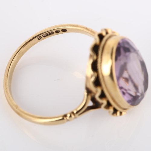 175 - A late 20th century 9ct gold amethyst dress ring, set with oval mixed-cut amethyst, hallmarks London... 