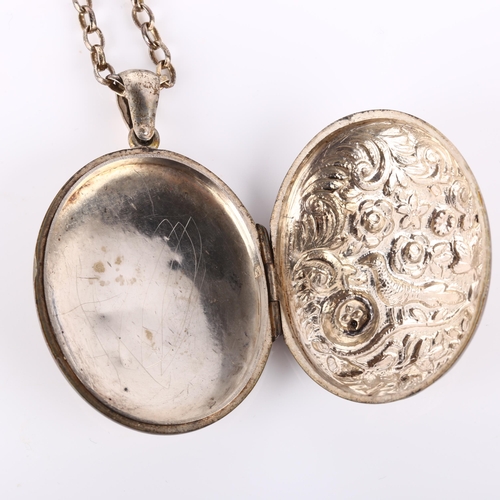 176 - A Victorian sterling silver photo locket pendant necklace, relief embossed bird and floral decoratio... 