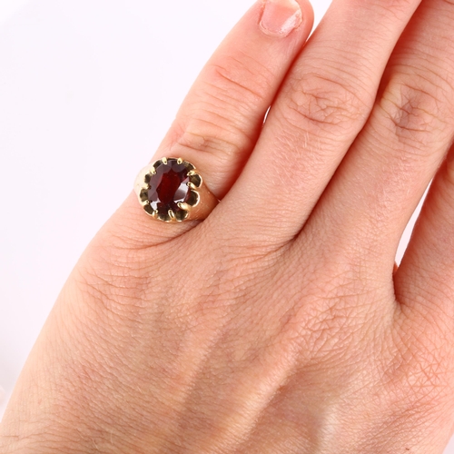 179 - An early 20th century 9ct rose gold garnet dress ring, set with oval mixed-cut garnet and engraved s... 