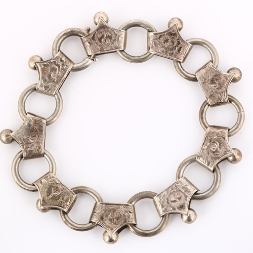 225 - A Victorian fancy link chain bracelet, unmarked silver settings with engraved floral decoration, bra... 