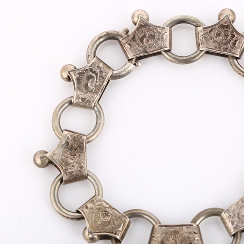 225 - A Victorian fancy link chain bracelet, unmarked silver settings with engraved floral decoration, bra... 