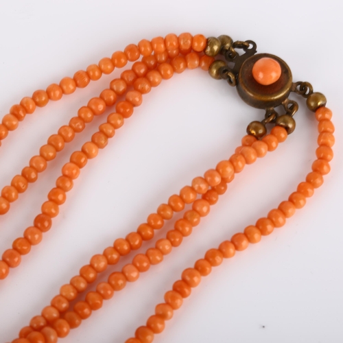 236 - A triple-strand graduated coral bead necklace, with gilt-metal clasp, beads ranging from 6.3mm - 2.6... 