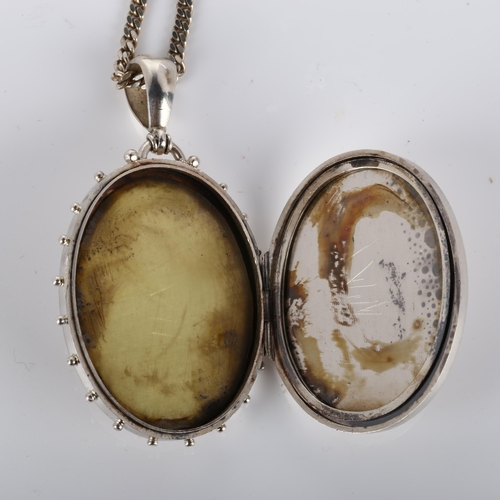 247 - A Victorian photo locket pendant necklace, unmarked silver settings with applied two-colour gold flo... 