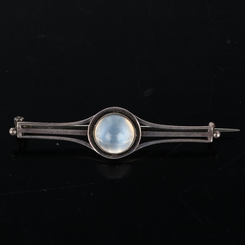 259 - An Arts and Crafts moonstone bar brooch, unmarked silver settings with round high cabochon moonstone... 