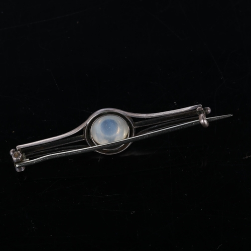 259 - An Arts and Crafts moonstone bar brooch, unmarked silver settings with round high cabochon moonstone... 