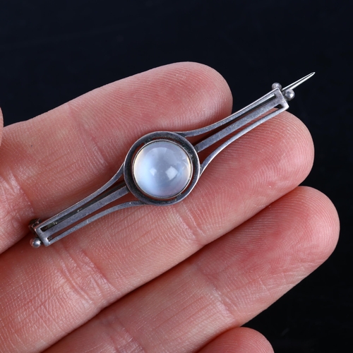 259 - An Arts and Crafts moonstone bar brooch, unmarked silver settings with round high cabochon moonstone... 