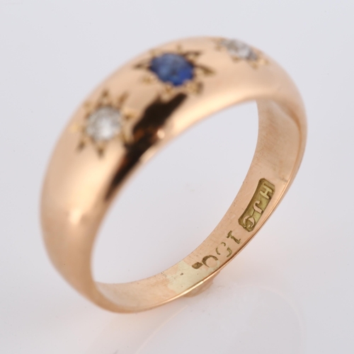 279 - An early 20th century 15ct rose gold three stone sapphire and diamond gypsy ring, total diamond cont... 