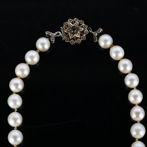 295 - A late 20th century single-strand pearl necklace, with 18ct white gold sapphire clasp, pearl diamete... 