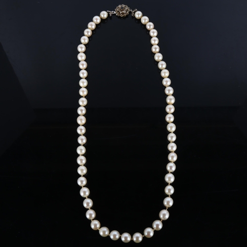 295 - A late 20th century single-strand pearl necklace, with 18ct white gold sapphire clasp, pearl diamete... 