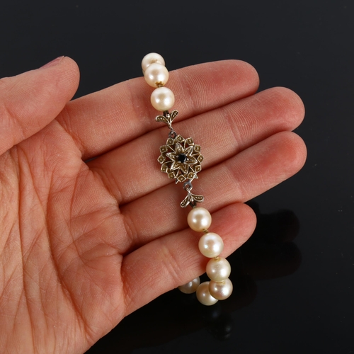 295 - A late 20th century single-strand pearl necklace, with 18ct white gold sapphire clasp, pearl diamete... 