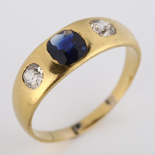 332 - An early 20th century three stone synthetic sapphire and diamond gypsy ring, unmarked gold settings ... 