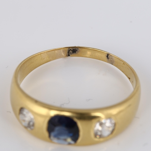 332 - An early 20th century three stone synthetic sapphire and diamond gypsy ring, unmarked gold settings ... 