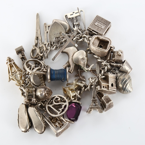 348 - A silver curb link charm bracelet, with large quantity of charms and silver heart padlock clasp, bra... 