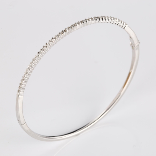 353 - A modern 9ct white gold diamond hinged bangle, set with modern round brilliant-cut diamonds, band wi... 