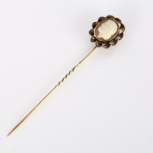 358 - A shell cameo stickpin, unmarked gold rope twist settings, with relief carved panel depicting male p... 