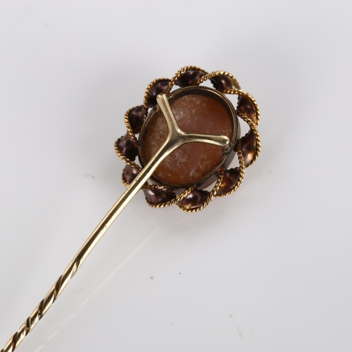 358 - A shell cameo stickpin, unmarked gold rope twist settings, with relief carved panel depicting male p... 