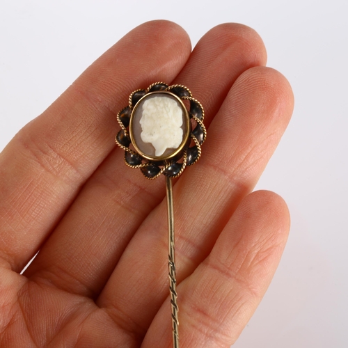 358 - A shell cameo stickpin, unmarked gold rope twist settings, with relief carved panel depicting male p... 