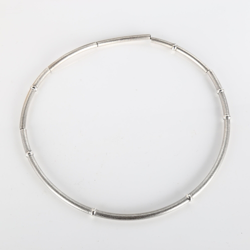 375 - LAPPONIA - a Finnish sterling silver necklace, segmented form with textured ground and raised bands,... 