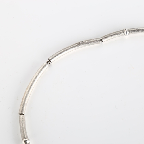 375 - LAPPONIA - a Finnish sterling silver necklace, segmented form with textured ground and raised bands,... 